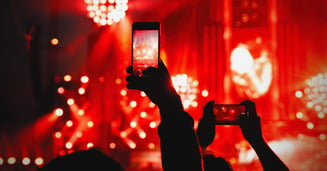 Rock concert with people holding up cellphones