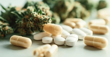 A photo of cannabis and pills on a table.